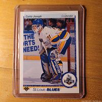 Front of Curtis Joseph rookie card from 1990-91 Upper Deck hockey series, showing player in St. Louis Blues goalie uniform in game action.