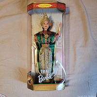 Full view of Thai Barbie doll in original clear plastic box showing traditional costume and overall packaging.