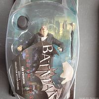 Original packaging front showing The Penguin figure and umbrella cane with visible damage to packaging.