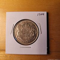 Reverse side showing Canadian coat of arms, date, and denomination.