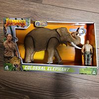 Full box view showing the elephant and Rock figures in packaging with Jumanji branding.