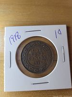 Reverse side of the 1918 Large Canadian One Cent coin showing 'ONE CENT CANADA 1918' and decorative border