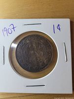 Front (reverse) view of the 1907 Canadian large cent coin showing ONE CENT and year 1907 with floral design.