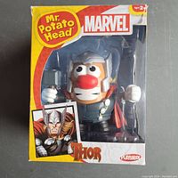 Photo of Mr. Potato Head toy as Marvel Thor, showing the toy in original sealed packaging with packaging design and branding visible