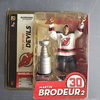 McFarlane Sports figure of Martin Brodeur in white New Jersey Devils jersey 30 with Stanley Cup trophy in original packaging