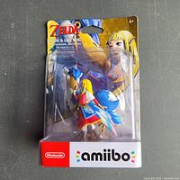 Front view of sealed Nintendo Zelda & Loftwing Amiibo in original blister packaging with visible package damage.