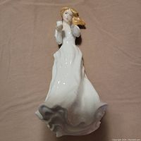 Porcelain figurine overview showing the figure from the front, capturing dress details and facial features.