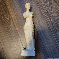 Front view of the Santini woman sculpture showing the detailed drapery and the missing arms.