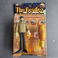 Front view of The Beatles Yellow Submarine figure and accessories in original blister packaging.