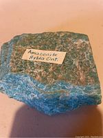 Close-up photo of the rough amazonite specimen with label 'Amazonite Hybla Ont.' visible on top.