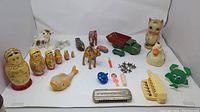 Front view of entire antique toy collection, showing nesting dolls, animal figures, toys, and musical instruments