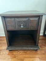 Pair of Kroeler wood nightstands shown from the front with drawer closed and open storage cubby below
