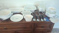 Overview of all CorningWare pieces and accessories arranged on dresser top