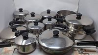 Overview of all copper-clad stainless steel cookware pieces including saucepans, frying pans, steamer pot, and accessories