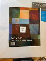 Photo of sealed pack of Coreboard Crescendo mat boards, showing 24x30 inch size and 15.5x19.5 inch inner opening