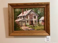 Full view of the framed painting showing the blacksmith shop scene with trees and greenery