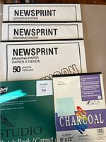 Photo of three Stevenson newsprint drawing paper pads each with 50 sheets, Pro Art charcoal paper pad with 24 sheets and Studio brand cartridge paper pad visible