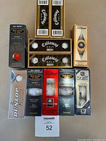 Photo showing all golf ball boxes arranged flat, displaying various brands and packaging.