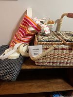 Wicker sewing box with floral fabric lids, piece of black sequin fabric, and white Velcro strips on table.