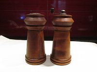 Front view of wooden salt and pepper shakers showing turned design