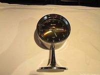 Front view of Bulova space age style alarm clock on chrome stand showing clock face, dial, and chrome finish.