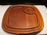 Top view of solid teak chip and dip tray showing square and round recessed compartments