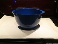 Blue 3-litre Rosti mixing bowl with pouring spout and rubber non-slip base flange, shown from front angle.