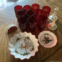 Full lot shown on wooden surface including all plates, glasses, candlesticks, and napkin holder