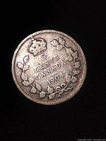 Obverse side of the 1904 Canada 5 cent coin showing denomination, crown and wreath design.
