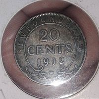 Front side showing denomination, year, and 'Newfoundland' with ornamental design.