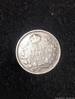 Obverse side of the 1914 Canadian 5 cent silver coin showing the denomination, crown, and wreath design.