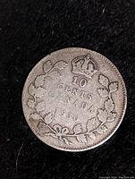 Obverse side of 1930 Canadian 10 cent silver coin showing denomination, crown, and wreath.