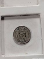 Reverse side of the 1945 British sixpence coin showing crowned GRVI and denomination.