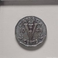 Image of the obverse side of the 1945 Canadian 5 cent coin showing 'CANADA', year 1945, large 'V' with a torch, maple leaves and 'CENTS' denomination.