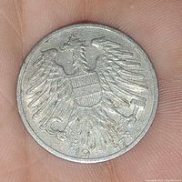 Reverse side of 1947 Austrian coin showing an eagle with shield and the year 1947.