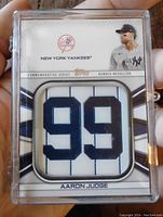 Front view of Aaron Judge jersey number 99 patch card in protective plastic case, showing card details and player image.