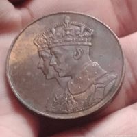 Obverse side of the 1939 Royal Visit coin showing the portrait of King George VI and Queen Elizabeth wearing crowns.