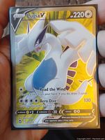 Front view of Lugia V full art holo foil Pokémon card, showing the holographic shine and the card text clearly.