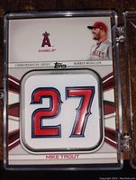 Front view of the Mike Trout commemorative insert card showing the number 27 patch, Angels logo, and player image.