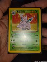 Photo of the single Nidorino Pokemon card held in hand showing the front artwork and text details.