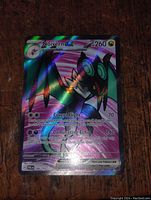 Front view of the Noivern GX Full Art Holo Foil card showing the holographic artwork and text, clear collectible card with ambient light highlighting the foil.