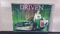 Full view of the framed 'DRIVEN' Dale Earnhardt Jr. NASCAR poster showing driver and racecar