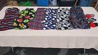 Photo showing six pairs of men's lounge pants laid side by side showing various patterns.