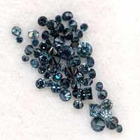 Loose blue diamonds scattered on white background