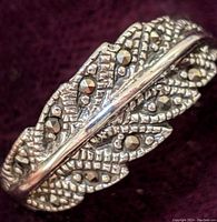 Close up photo of the sterling silver marcasite ring showing detailed leaf pattern with marcasite stones on a dark background.