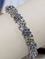 Close-up of floral sapphire cluster link