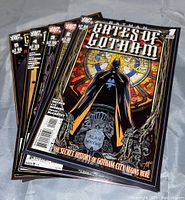 Photo showing five Batman Gates of Gotham comic books stacked, highlighting the front cover artwork and condition.