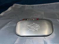 Closed metal case with NHL logo emblem on the lid