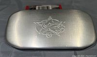 Closed metal case with NHL All-Stars logo embossed on top, silver color with a brushed metal finish.