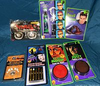 Full lot showing all items including zombie glasses, green hair gel, devil horns, flashing teeth, makeup crayons, red base makeup, and nose putty.